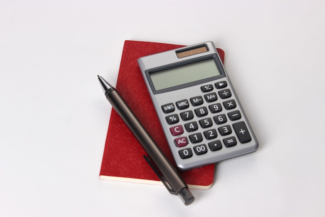 calculating equipment in the office using books, calculators and pens